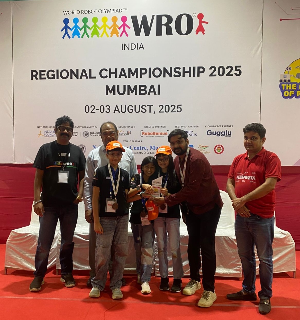 Team UniPod receiving the 3rd place trophy at the WRO 2025 Mumbai Regional